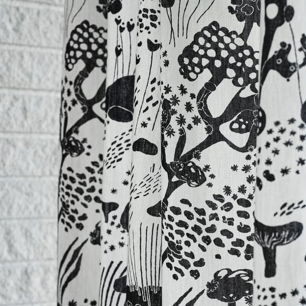 Black-and-white curtains with giraffe and leopard prints.