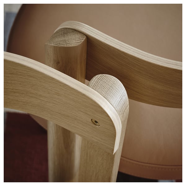 Elegant wooden chair close-up. Crafted with smooth, curved oak veneer, showcasing fine grain detail and quality craftsmanship.