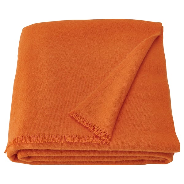 Bright orange merino wool throw, warm & soft, folded neatly. Part of STOCKHOLM 2025 collection, showcasing scandinavian design.