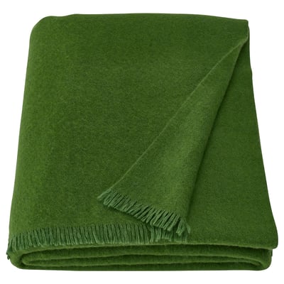 Green ikea STOCKHOLM 2025 throw, rectangular, soft wool/merino blend, fringe edges.