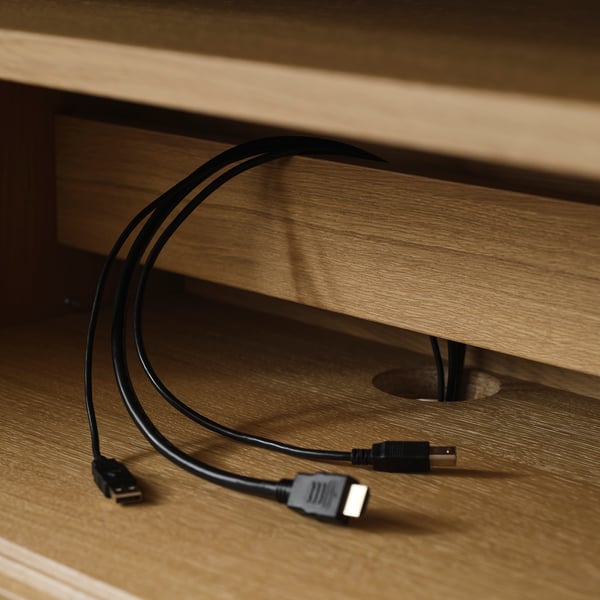 Wooden tv bench with adjustable feet and sliding doors, showcasing cable management with visible cords.