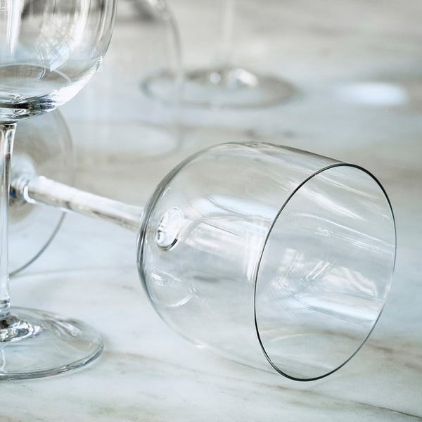 Thin, handcrafted wine glasses on a sleek surface, showcasing elegant design and craftsmanship.