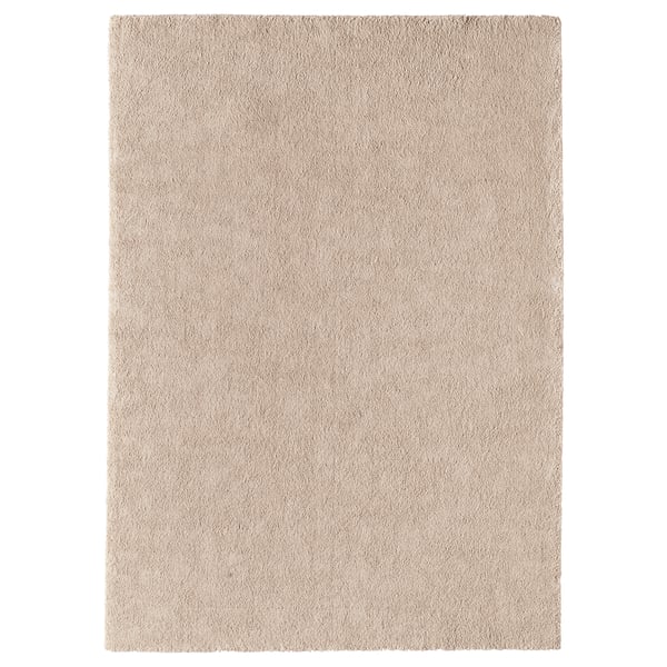 A light beige STOENSE rug, rectangular, with a soft, thick, plush texture, and a subtle sheen.