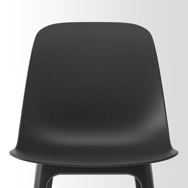 Black chair with smooth, moulded seat and backrest. Sturdy legs and a modern, sleek design.