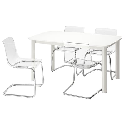 A white STRANDTORP extendable table with four clear plastic chairs, featuring chrome frames. The table and chairs have modern, sleek designs.