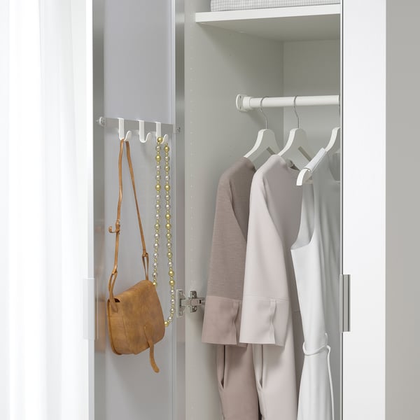 A wardrobe with mirror doors reflects light, saving space and aiding in getting dressed.