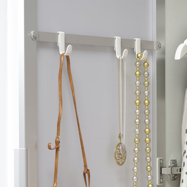 A platsa door with mirrored surface and extendable handles, providing storage behind it.