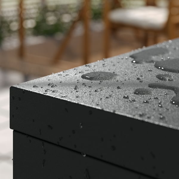 Black outdoor cabinet with rain droplets, durable powder-coated steel, adjustable feet, ideal for balconies, hallways, or bathrooms.