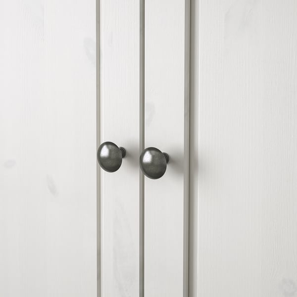 Two white vertical doors with round, dark knobs, showing high-quality finish and durable materials.