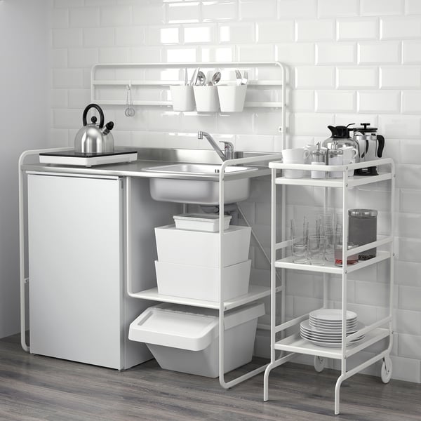 Compact kitchen with sink, storage, and cooking area, ideal for small spaces. Includes shelves and utensils for efficient use.