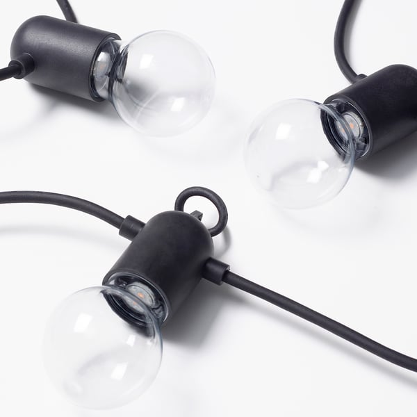 Modern string lights with black casings and clear globes for outdoor decorative lighting.