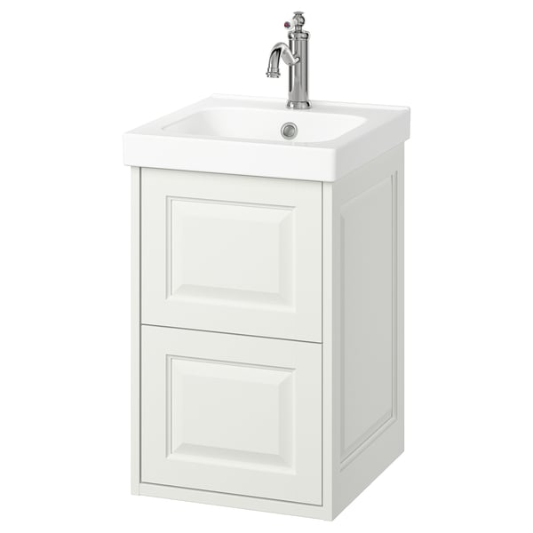 A white TÄNNFORSEN bathroom cabinet with a ceramic sink and chrome fixtures, showcasing a classic design with beveled edges.