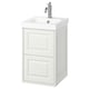 A white TÄNNFORSEN bathroom cabinet with a ceramic sink and chrome fixtures, showcasing a classic design with beveled edges.