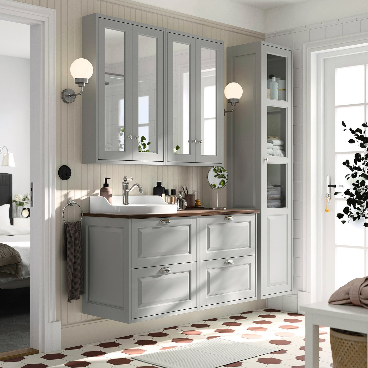 Modern grey bathroom with TÄNNFORSEN double vanity, mirror cabinets, and patterned floor. Sinks and storage surround a spacious countertop.