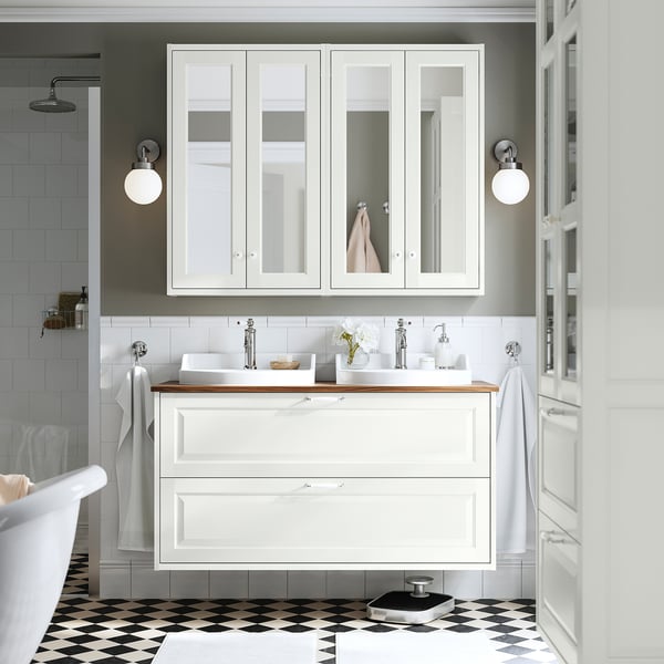 Modern bathroom featuring white TÄNNFORSEN cabinet set with mirrors, sinks, and checkerboard floor.