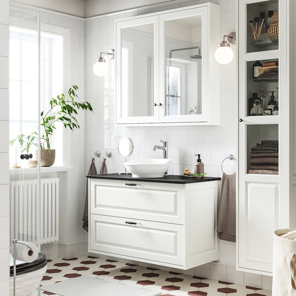 Elegant white TÄNNFORSEN vanity with round sink, mirror cabinets, and chequered floor.