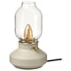 A TÄRNABY lamp, white with dimmable warm light and flickering bulb.