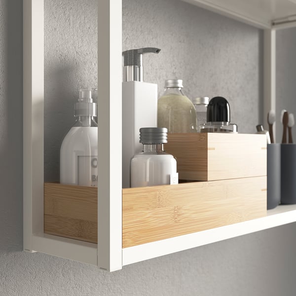 Shelf with decorations: bottles, containers, and trays. Organises bathroom items neatly.
