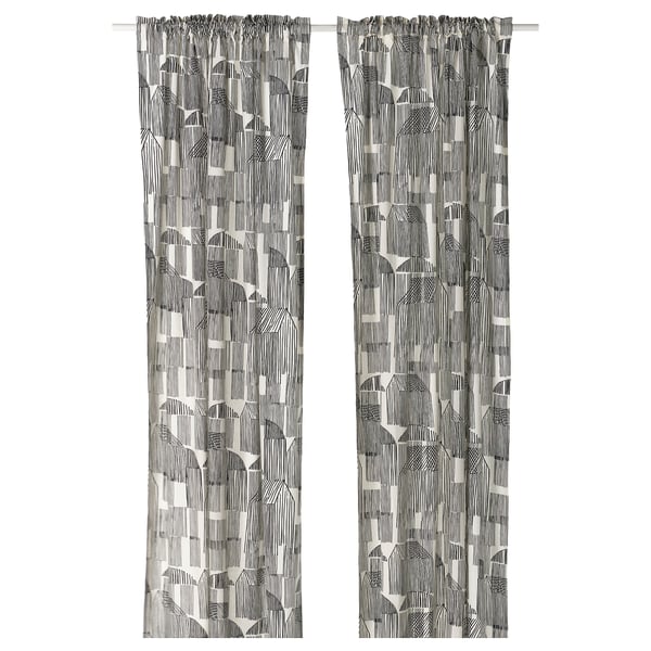 Black & white patterned curtains with sketch design, rustic cotton/jute blend, hanging straight.