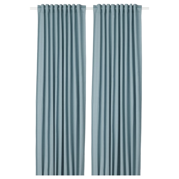 Two solid blue curtains hang side by side. Simple, elegant design with rod pocket top. Ideal for privacy and light control.