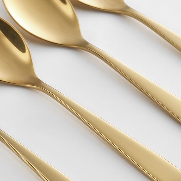 Golden espresso spoons sleek, metallic design. Arranged in a neat row. Reflective, quality finish.
