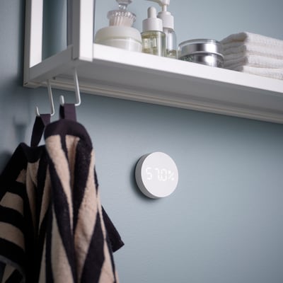 Round white smart temperature and humidity sensor. Displays readings on screen. Made of abs plastic.