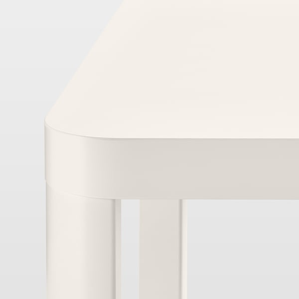 Modern white table with smooth rounded edges and sturdy legs.