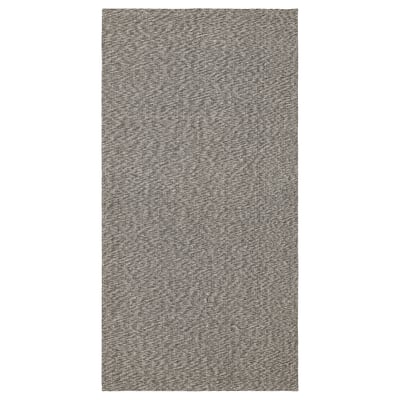 A TIPHEDE rectangular cotton rug with a grey and white chequered pattern, ideal for various spaces and easy to clean.