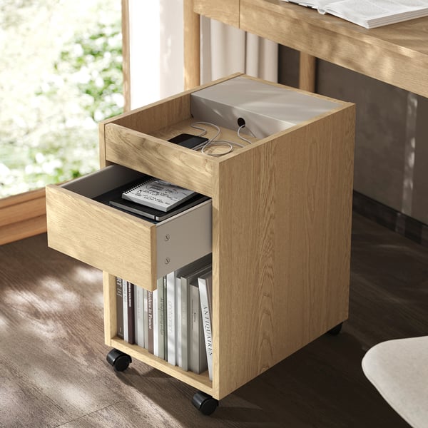 Wooden mobile drawer unit with open bookshelf. Holds books, notebooks, and small items in a stylish way.