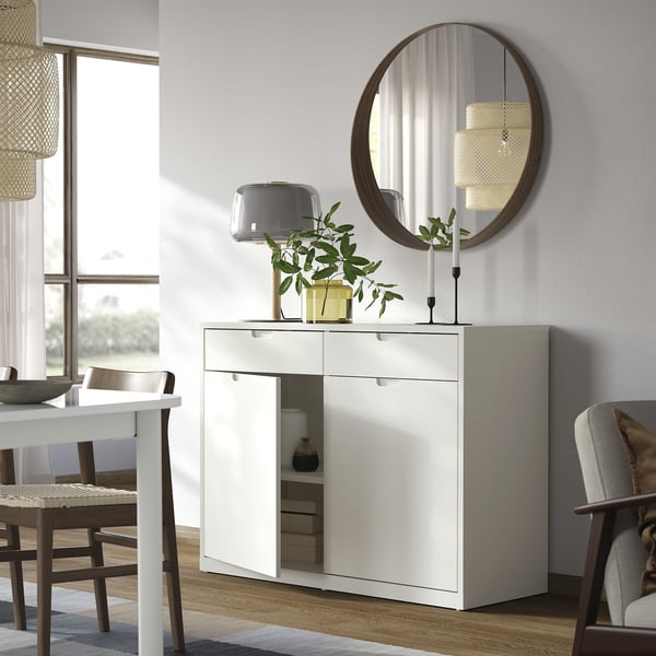 White TONSTAD sideboard, modern design, round mirror, two shelves, soft-close drawers, plants, dining room.