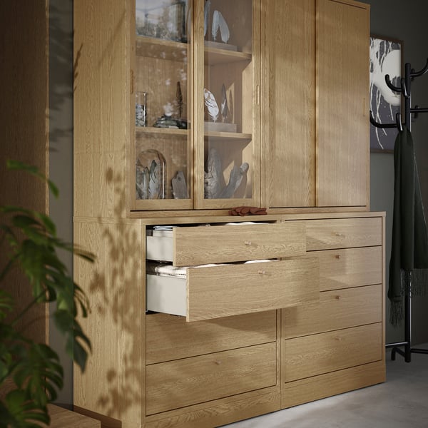 Wooden cabinet with open drawers, displaying decor items, in living space.