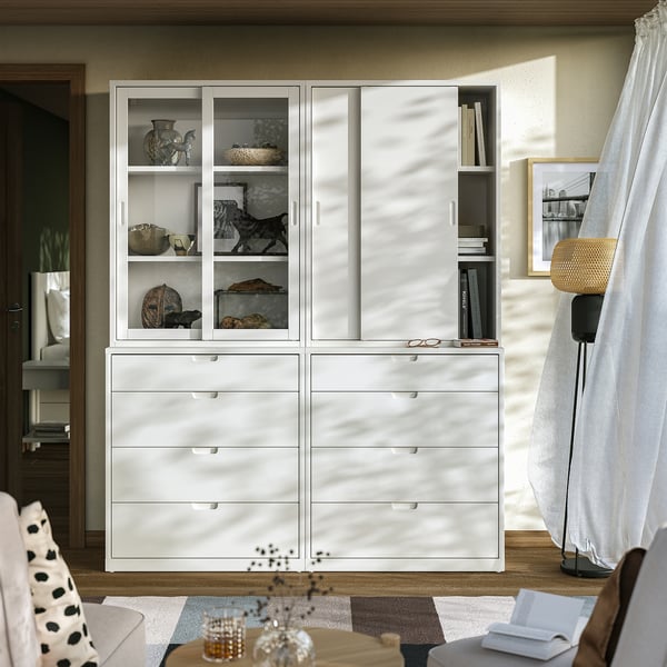 White TONSTAD furniture set with glass doors and drawers, displaying decorative items. Soft-close drawers, clean lines.