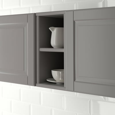 Open kitchen cabinet with two shelves displaying a jug and a bowl, part of the TORNVIKEN series.