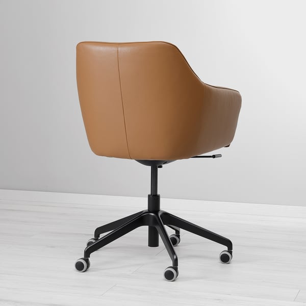 Brown leather office chair with adjustable height and casters. High back for support, placed on white wood floor against a wall.