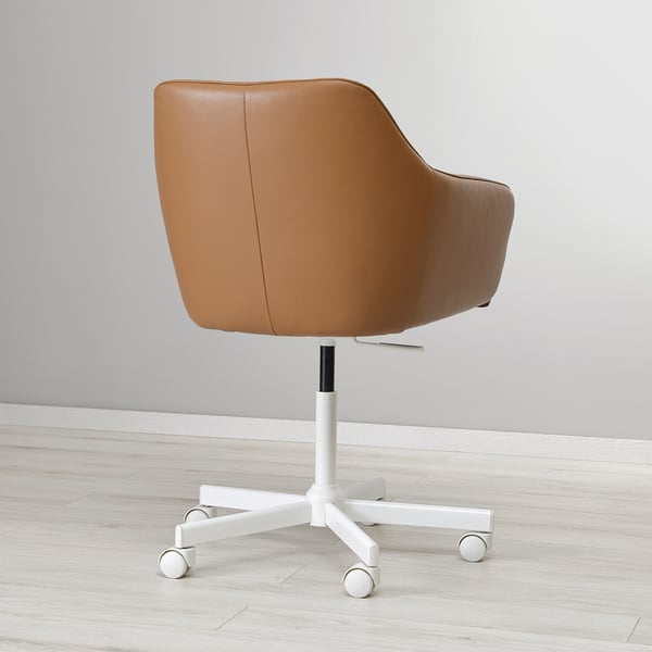 Modern tan leather swivel office chair with adjustable height on light wooden floor.
