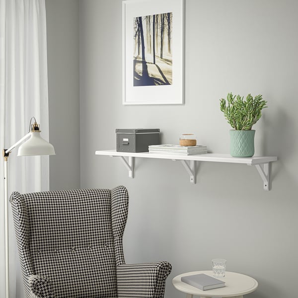 TRANHULT shelf above houndstooth armchair with decor. Modern simple meets cosy comfort.