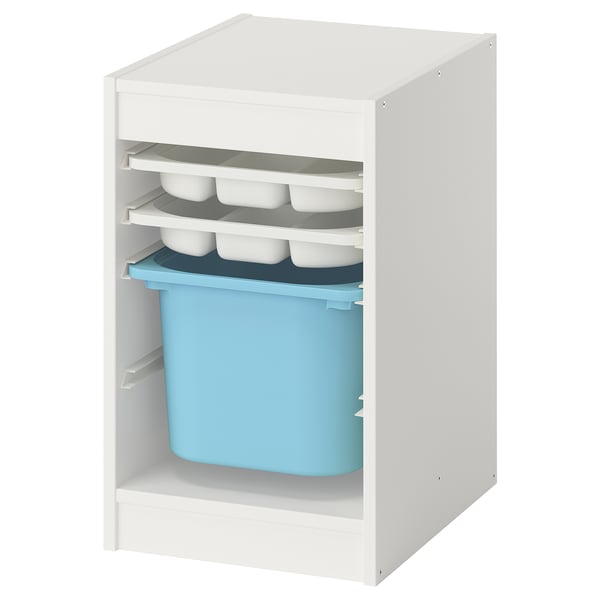A white TROFAST storage unit with open shelves. It blue and gray plastic trays and containers.