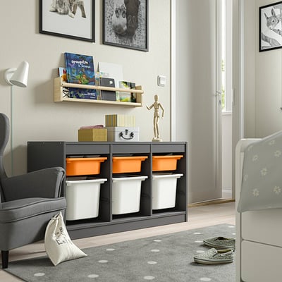TROFAST grey unit with orange/white bins, toys, books, figure, photos, under large window