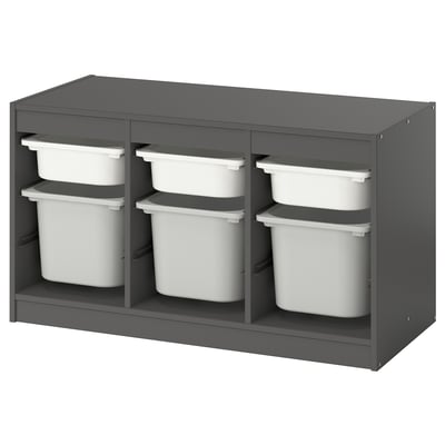 A TROFAST gray storage unit with white plastic bins, designed for children. It has a modern, organized look with adjustable compartments.