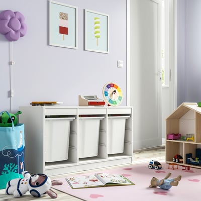 Kids playroom with TROFAST storage, toys, books, rug, art, lamp, dollhouse.