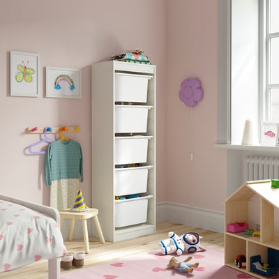 Kids room with TROFAST storage, white bins, pink walls, heart rug.