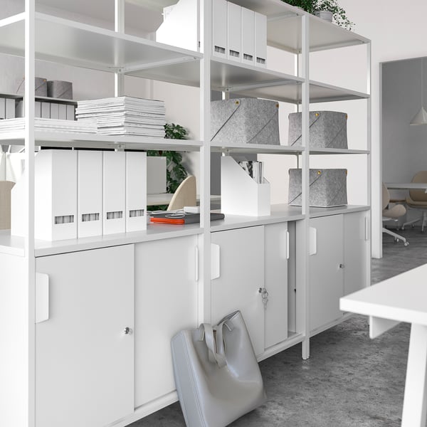 Modern white office cabinet, double-sided with open and closed storage, gray bins on top.