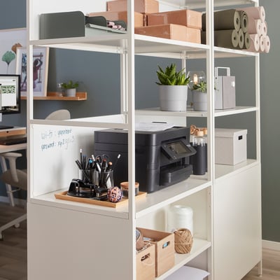 TROTTEN storage unit in office, separating workspace with printer, plant, stationery.