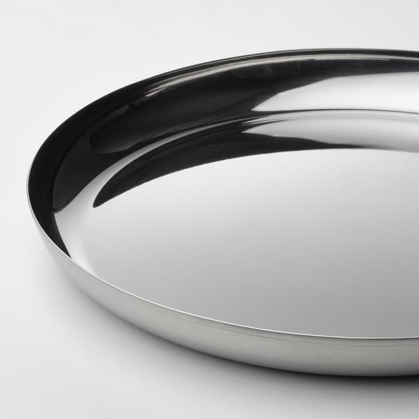 Sleek, round stainless steel serving tray; polished, reflective surface; thin, smooth edge.