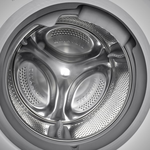 Interior of combined washer/dryer showing titanium drum with multiple compartments for washing and drying.