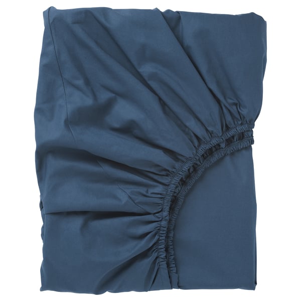 Blue fitted bed sheet, wrinkled, deep pockets, elastic edges, soft.