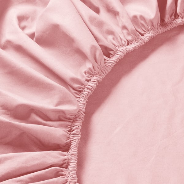 A close-up of a pink fitted sheet with fine stitching and smooth, crisp fabric, emphasising its quality and texture.