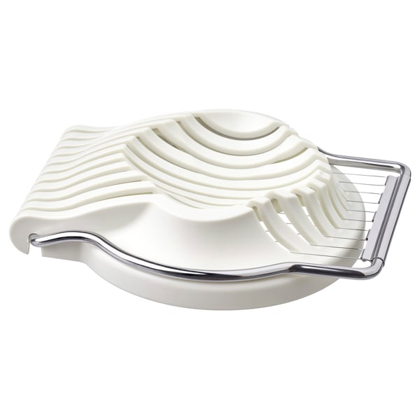 A white UPPFYLLD egg slicer with stainless steel accents, designed for slicing eggs and other soft foods.