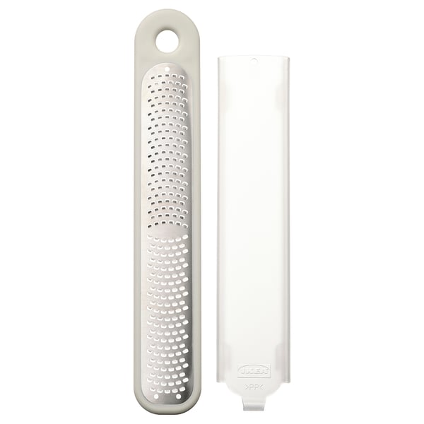 UPPFYLLD grater in white, round handle, stainless steel holes, plastic protector.