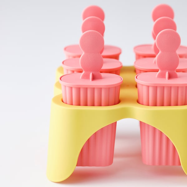 Guess ice pop mould; bright pink moulds in yellow stand; clear, vibrant design
